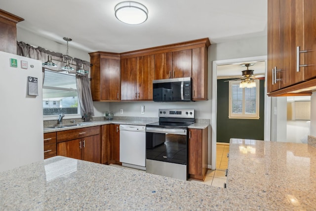 3132 Stafford Dr, Nashville, TN 37214 - kitchen featuring plenty of natural light, a sink, light stone counters, ceiling fan, and appliances with stainless steel finishes
