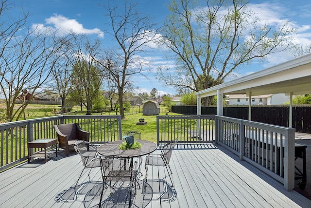 3132 Stafford Dr, Nashville, TN 37214 - wooden terrace featuring a shed, an outbuilding, a fenced backyard, a lawn, and outdoor dining area