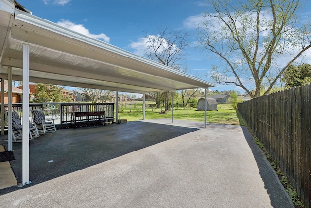 3132 Stafford Dr, Nashville, TN 37214 - view of parking / parking lot featuring driveway, a detached carport, a fenced backyard, and a storage unit
