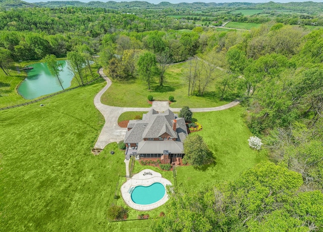 bird's eye view with a forest view and a water view