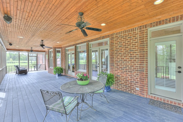 deck featuring ceiling fan and french doors