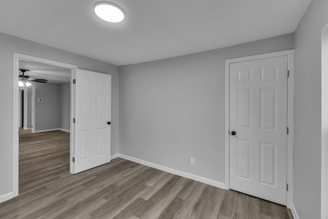 unfurnished bedroom featuring baseboards and wood finished floors
