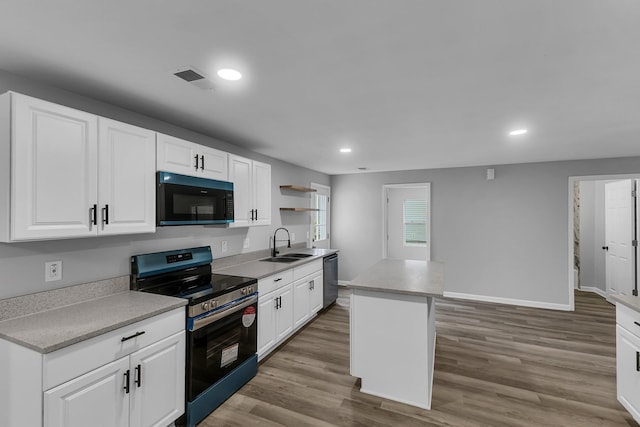 kitchen with white cabinetry, open shelves, wood finished floors, a sink, and stainless steel appliances