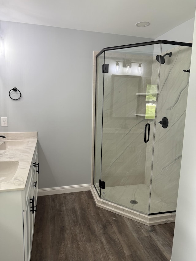 135 Locust Dr, Erin, TN 37061 - bathroom featuring wood finished floors, double vanity, and a stall shower
