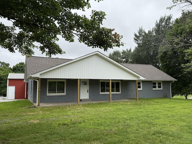 135 Locust Dr, Erin, TN 37061 - view of front facade featuring a front yard, roof with shingles, and a storage shed