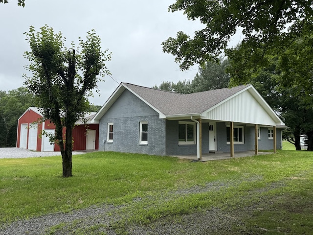 135 Locust Dr, Erin, TN 37061 - view of front of house with a front yard, roof with shingles, driveway, and a detached garage