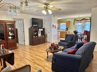 1701 Jamie Dr, Columbia, TN 38401 - living room featuring light wood-style flooring and ceiling fan with notable chandelier