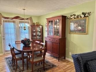 1701 Jamie Dr, Columbia, TN 38401 - dining area featuring a notable chandelier, baseboards, and light wood-style flooring
