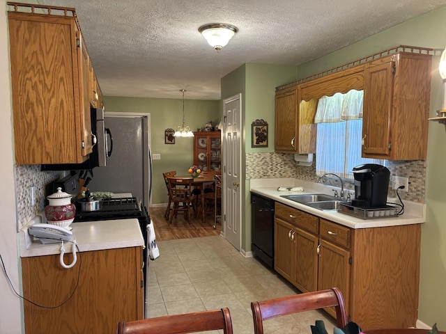 1701 Jamie Dr, Columbia, TN 38401 - kitchen featuring a sink, light countertops, backsplash, brown cabinetry, and black appliances