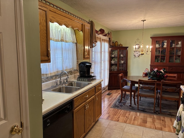 1701 Jamie Dr, Columbia, TN 38401 - kitchen with a chandelier, dishwasher, a sink, light countertops, and hanging light fixtures