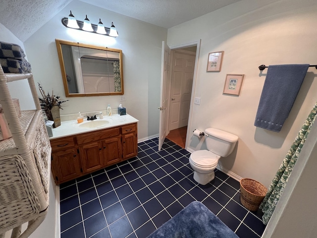 full bath with toilet, vanity, baseboards, and a textured ceiling