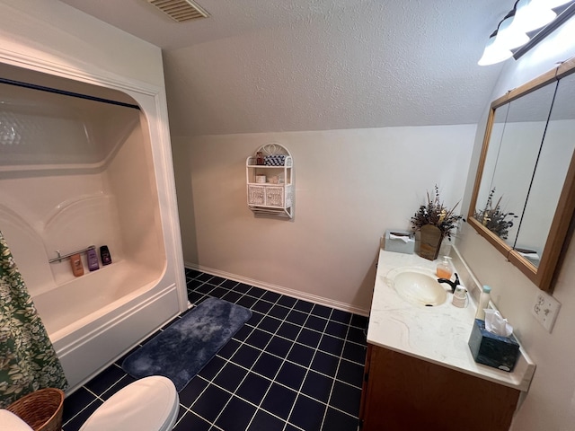 bathroom with tile patterned flooring, vanity, lofted ceiling, a textured ceiling, and visible vents