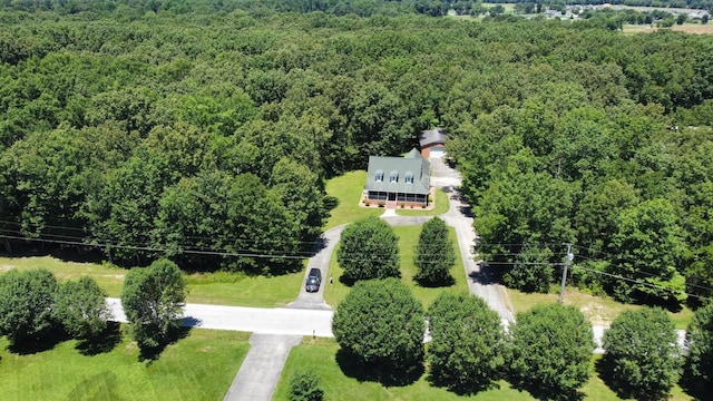 birds eye view of property with a wooded view