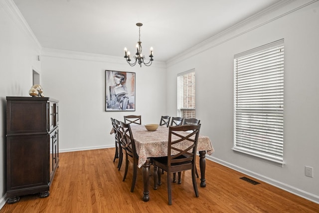 513 Cold Stream Pl, Nashville, TN 37221 - dining area featuring visible vents, crown molding, baseboards, light wood-type flooring, and an inviting chandelier