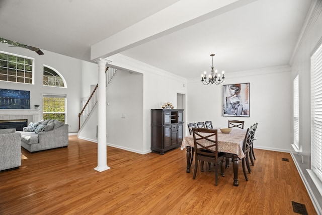 513 Cold Stream Pl, Nashville, TN 37221 - dining area featuring stairway, light wood-type flooring, ornamental molding, visible vents, and a fireplace