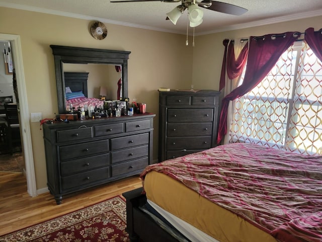 1148 Brittany Park Ln, Antioch, TN 37013 - bedroom featuring a textured ceiling, crown molding, ceiling fan, and light wood-type flooring