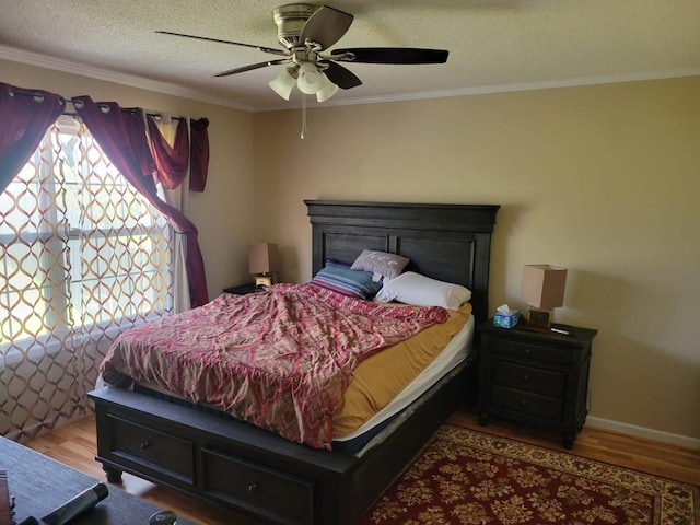 1148 Brittany Park Ln, Antioch, TN 37013 - bedroom featuring crown molding, wood finished floors, a textured ceiling, baseboards, and ceiling fan