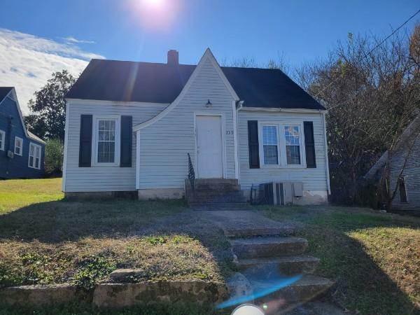 347 E Washington St, Pulaski, TN 38478 - view of front facade featuring a chimney and a front lawn