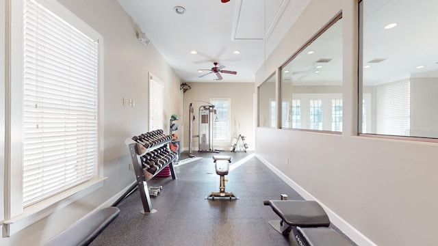 exercise area with a ceiling fan, baseboards, attic access, and recessed lighting
