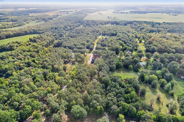 birds eye view of property with a forest view