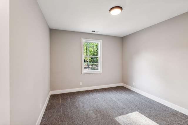 unfurnished room featuring carpet flooring, baseboards, and visible vents