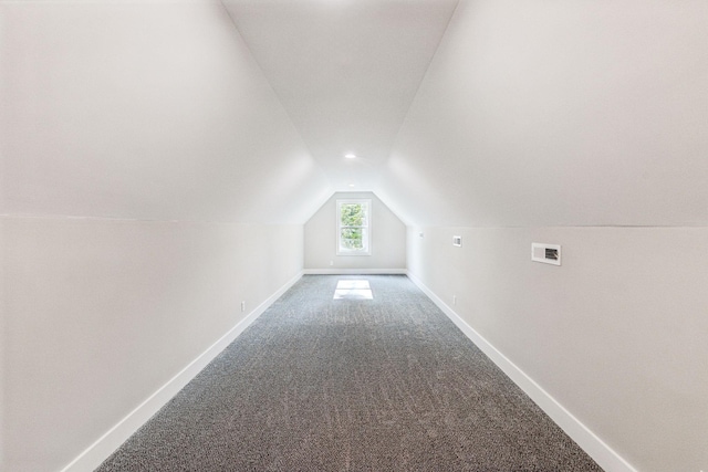 bonus room with baseboards, lofted ceiling, visible vents, and carpet