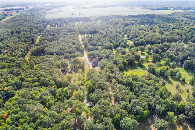 drone / aerial view with a wooded view