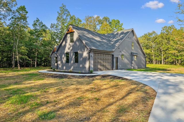 view of property exterior featuring a lawn, driveway, an attached garage, and roof with shingles