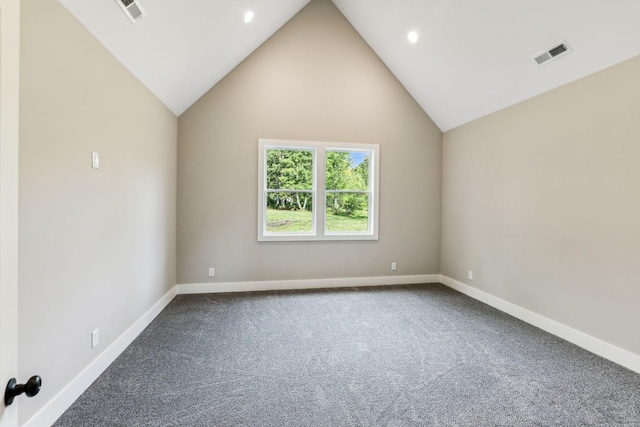 spare room with baseboards, visible vents, and dark colored carpet