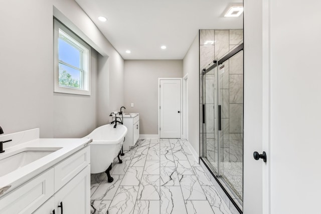 bathroom with a freestanding tub, marble finish floor, a stall shower, and vanity