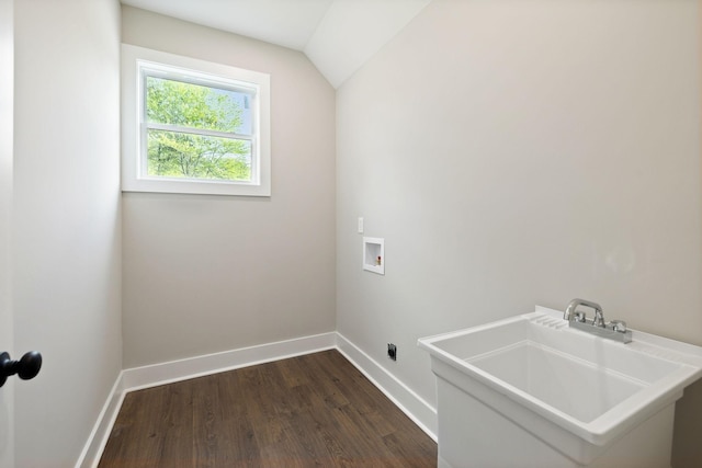 laundry area featuring hookup for a washing machine, baseboards, laundry area, dark wood-type flooring, and a sink