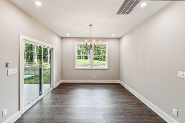 unfurnished dining area featuring baseboards, visible vents, dark wood-type flooring, and a healthy amount of sunlight