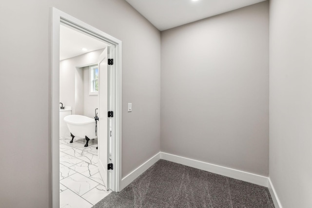 corridor featuring baseboards and marble finish floor