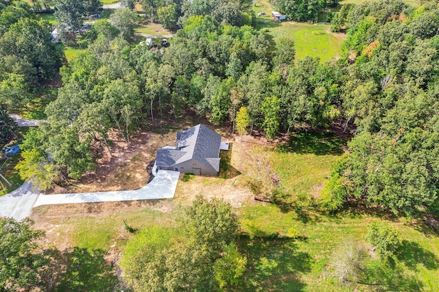 drone / aerial view with a wooded view