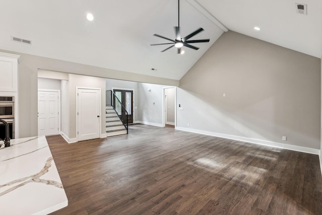 unfurnished living room with stairs, visible vents, ceiling fan, and dark wood-style floors