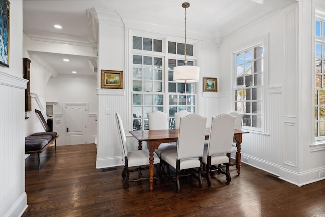 dining space featuring crown molding, visible vents, recessed lighting, wood finished floors, and a decorative wall