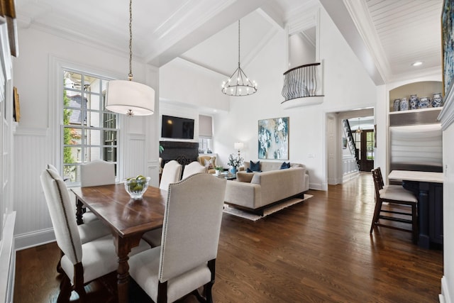 dining area with an inviting chandelier, beam ceiling, crown molding, baseboards, and dark wood-style flooring
