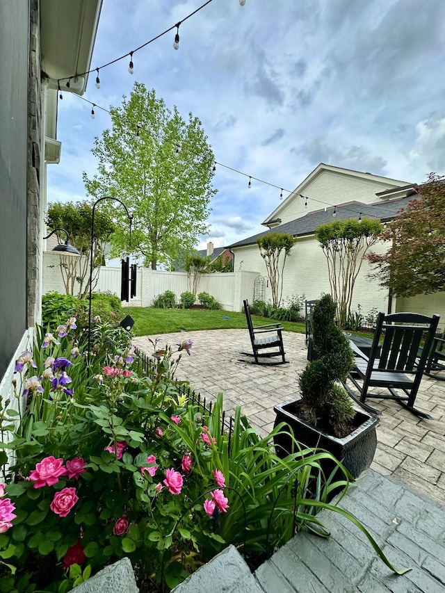 view of property's community featuring fence and a patio area