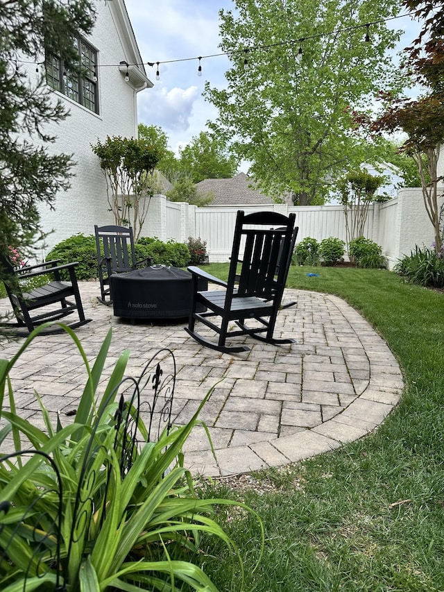 view of patio featuring a fire pit and a fenced backyard
