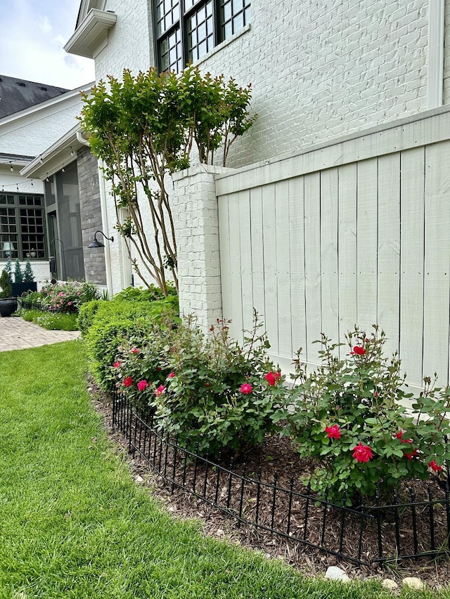 view of property exterior with a yard and fence