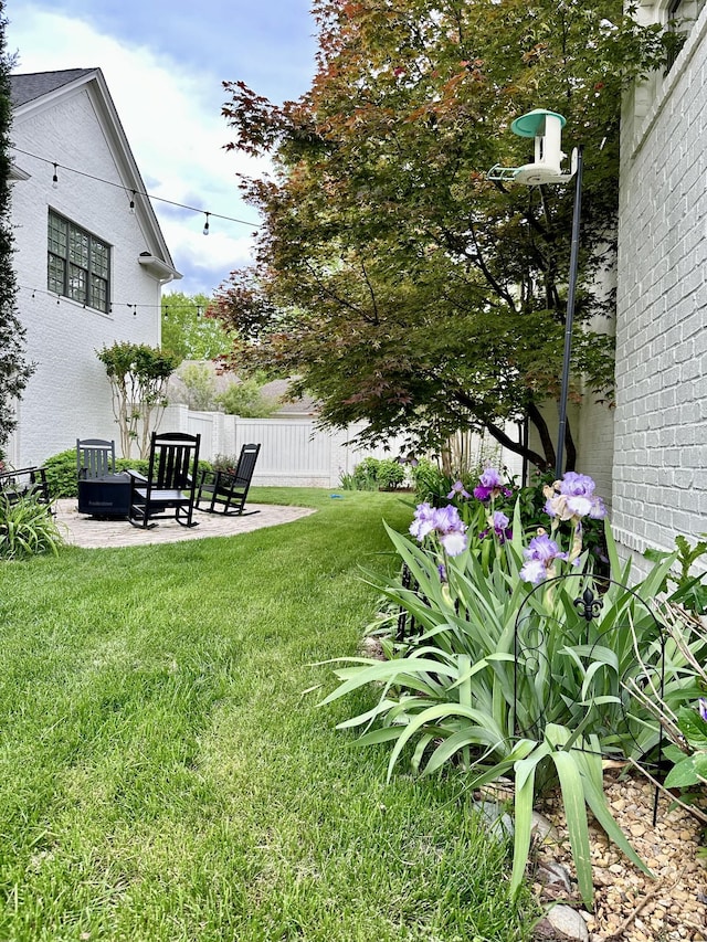 view of yard featuring fence and a patio area