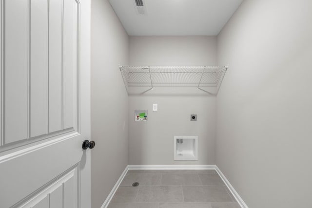 2539 Rafiki Dr, Clarksville, TN 37042 - washroom with hookup for an electric dryer, baseboards, hookup for a washing machine, and light tile patterned floors