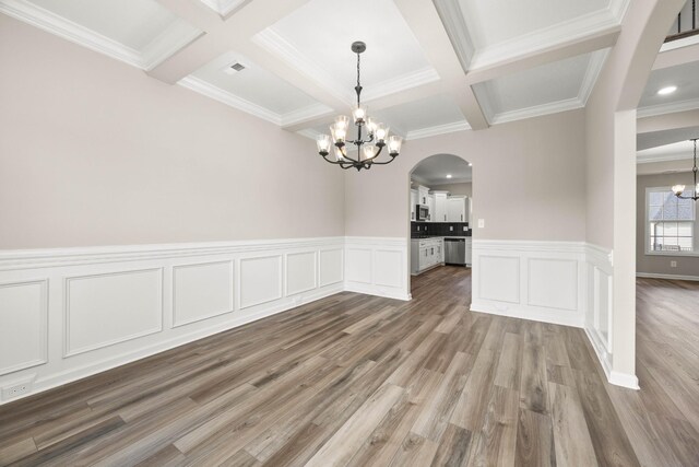 2539 Rafiki Dr, Clarksville, TN 37042 - unfurnished dining area with a chandelier, arched walkways, coffered ceiling, beam ceiling, and wood finished floors