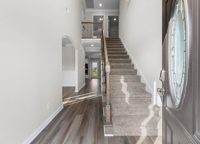 2539 Rafiki Dr, Clarksville, TN 37042 - foyer entrance with arched walkways, crown molding, stairway, a towering ceiling, and wood finished floors