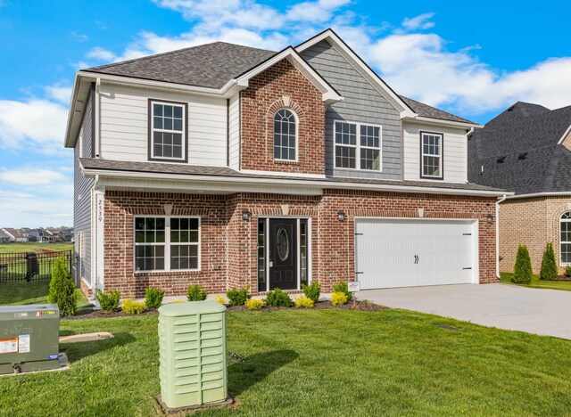 2539 Rafiki Dr, Clarksville, TN 37042 - traditional-style house featuring driveway, brick siding, an attached garage, and roof with shingles