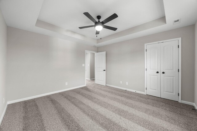 2539 Rafiki Dr, Clarksville, TN 37042 - unfurnished bedroom featuring a tray ceiling, baseboards, and carpet floors