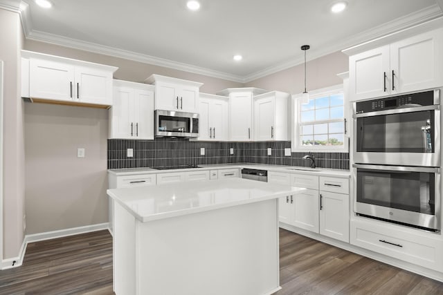 2539 Rafiki Dr, Clarksville, TN 37042 - kitchen with stainless steel appliances, white cabinets, dark wood finished floors, light countertops, and backsplash