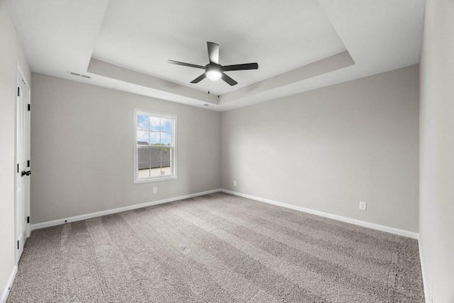 2539 Rafiki Dr, Clarksville, TN 37042 - empty room featuring a raised ceiling, a ceiling fan, baseboards, and carpet floors