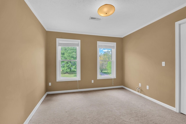 unfurnished room with ornamental molding, carpet, baseboards, and visible vents