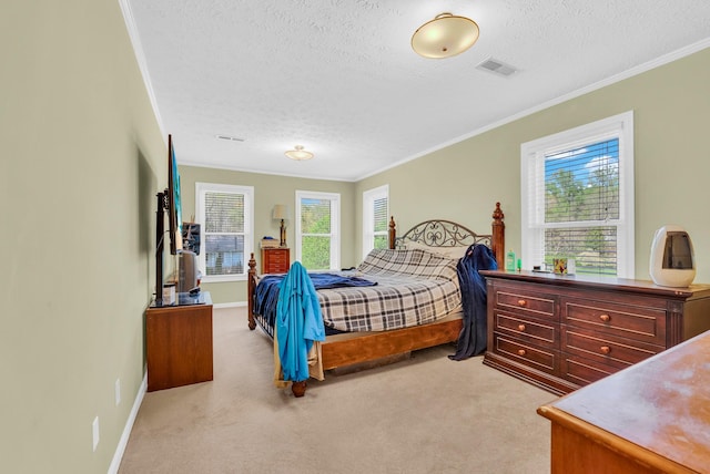 bedroom with crown molding, a textured ceiling, carpet floors, and visible vents